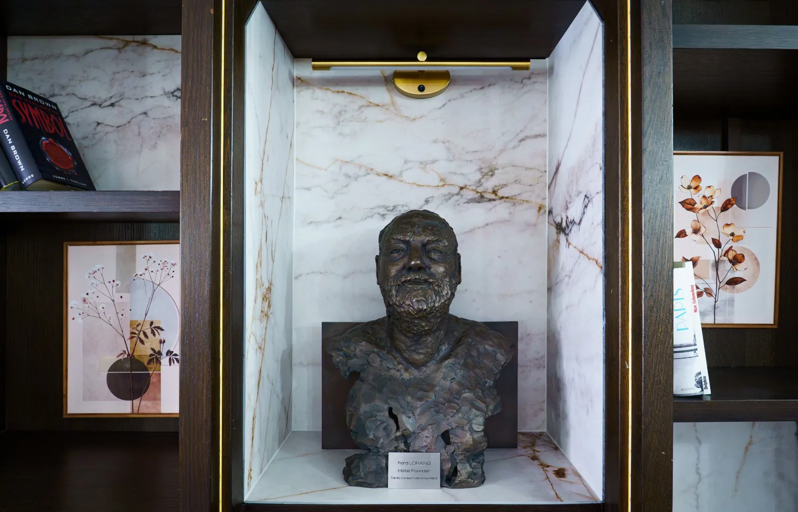 Bronze bust of Ferd Lorang, the hotel's founder, in a marble niche