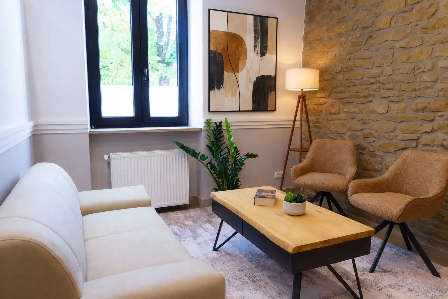 The Bar Lounge: cream sofa, armchairs and a natural stone wall