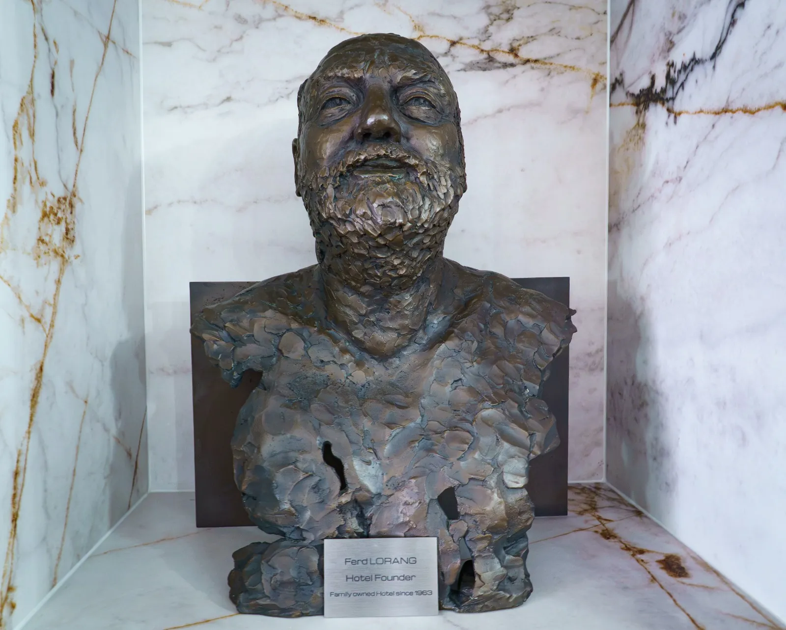 Close-up of the bronze bust of Ferd Lorang, the hotel's founder