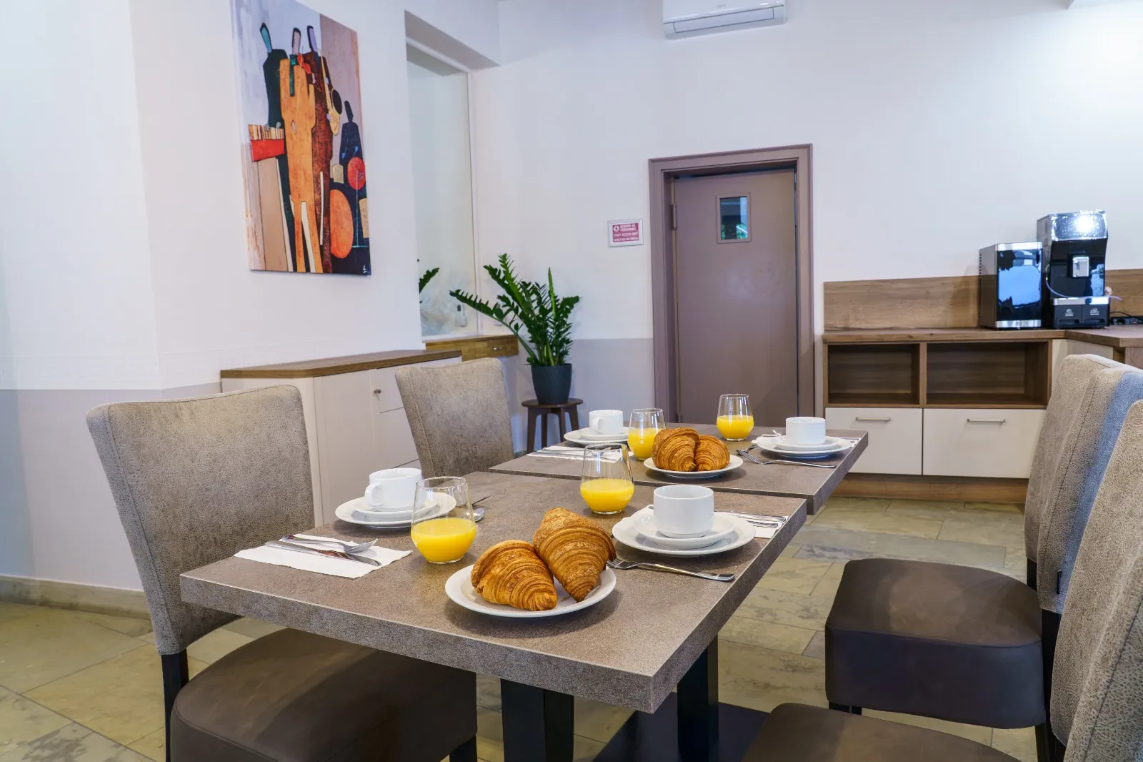 Table set with croissants, orange juice and coffee